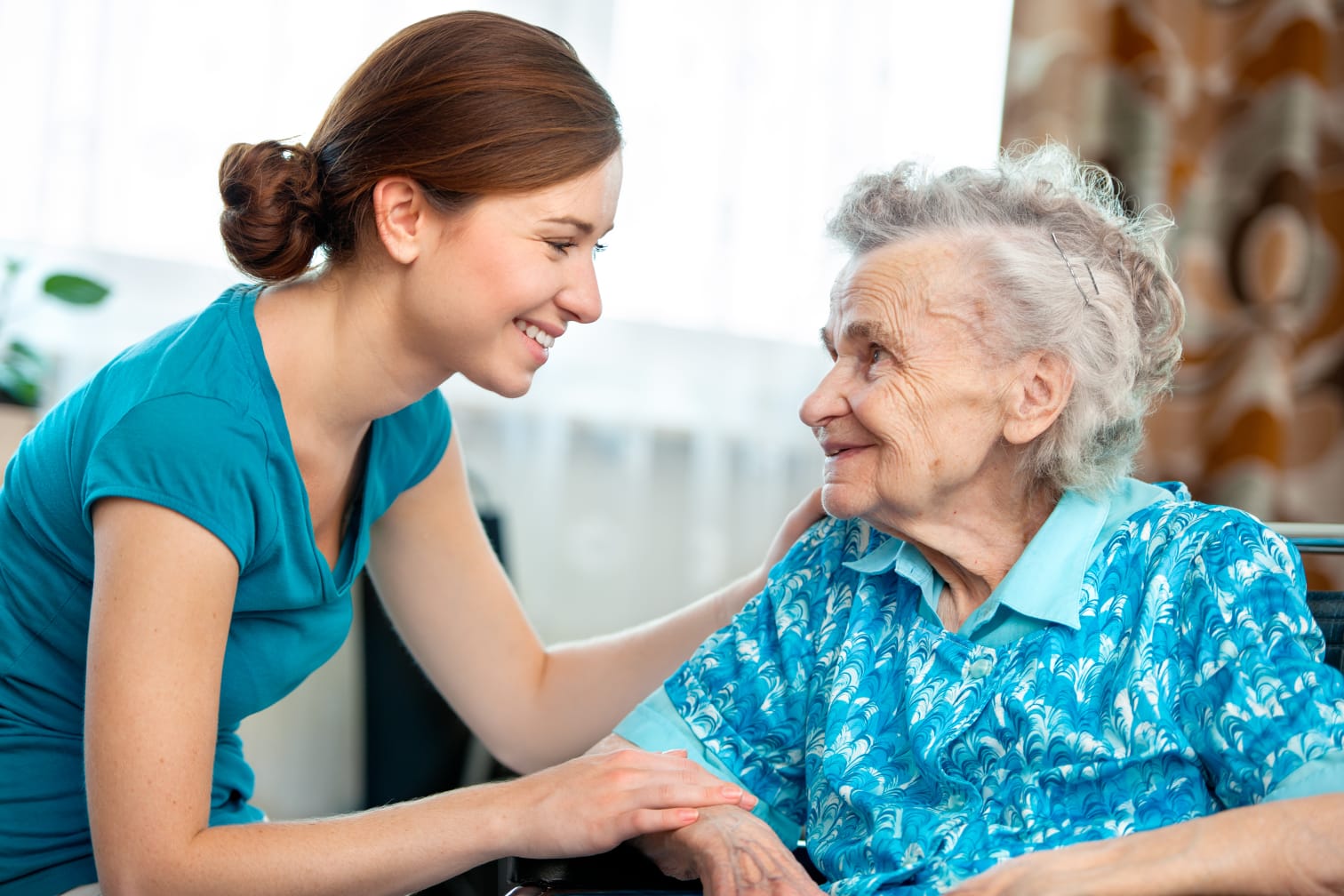 A TC Care carer holding hands with a client